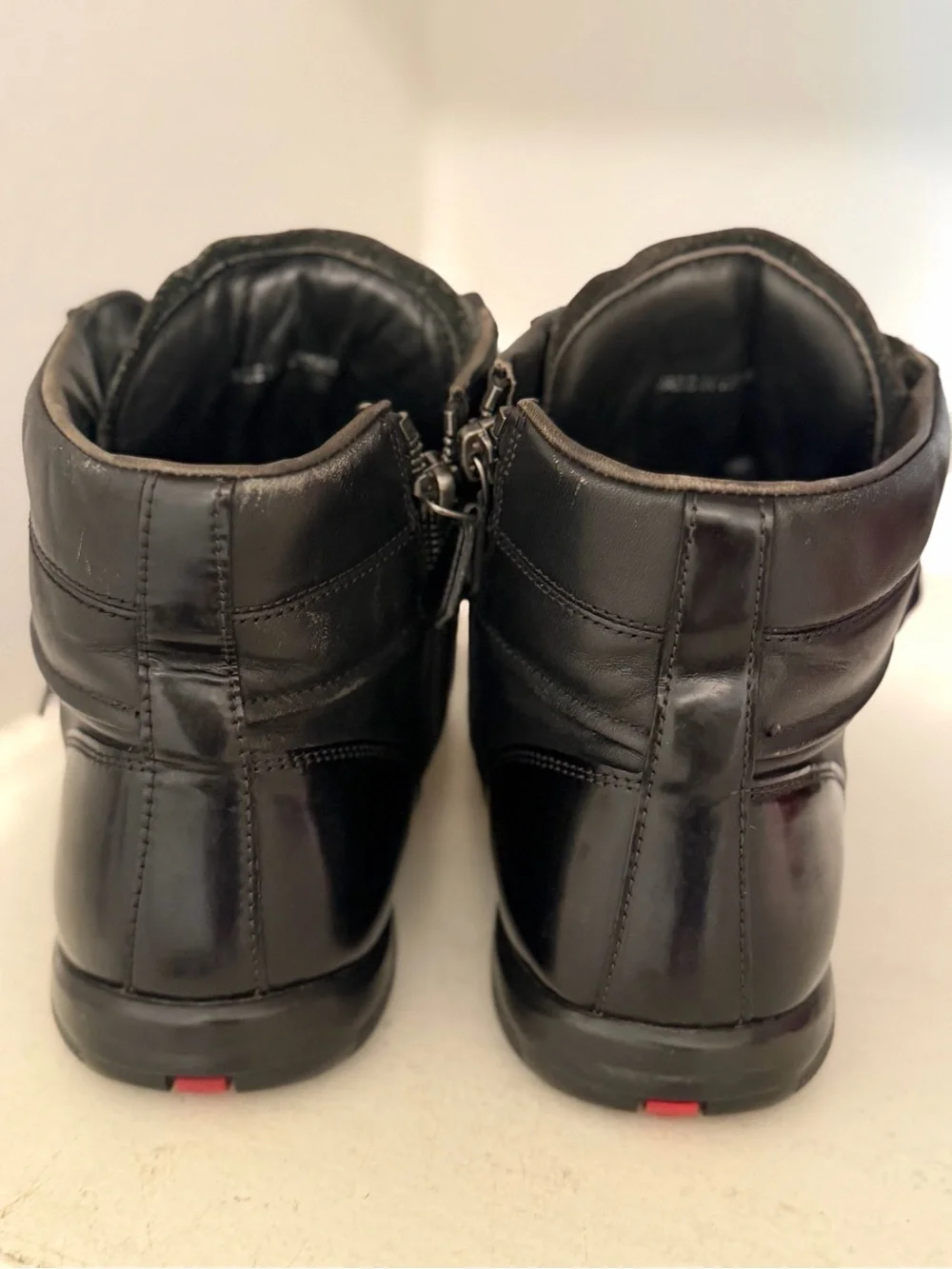 Authentic Prada Black High-Top Leather Sneakers with Red Logo